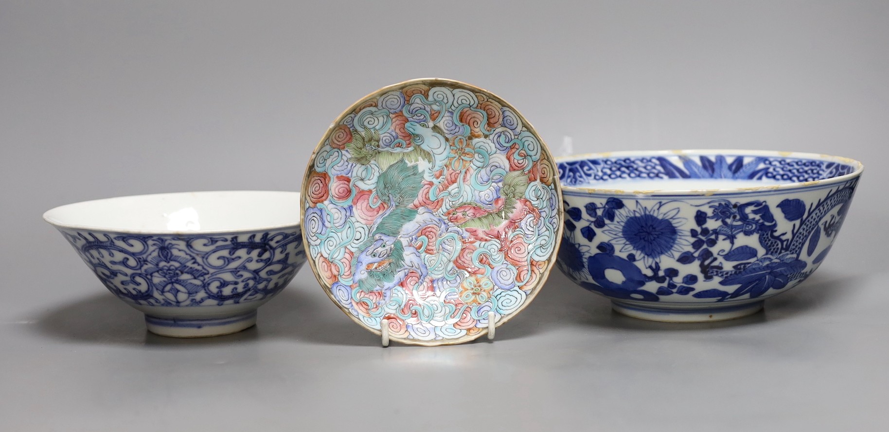 A Chinese blue and white dragon bowl, another blue and white bowl and a saucer, 19th century, largest 20.5cm